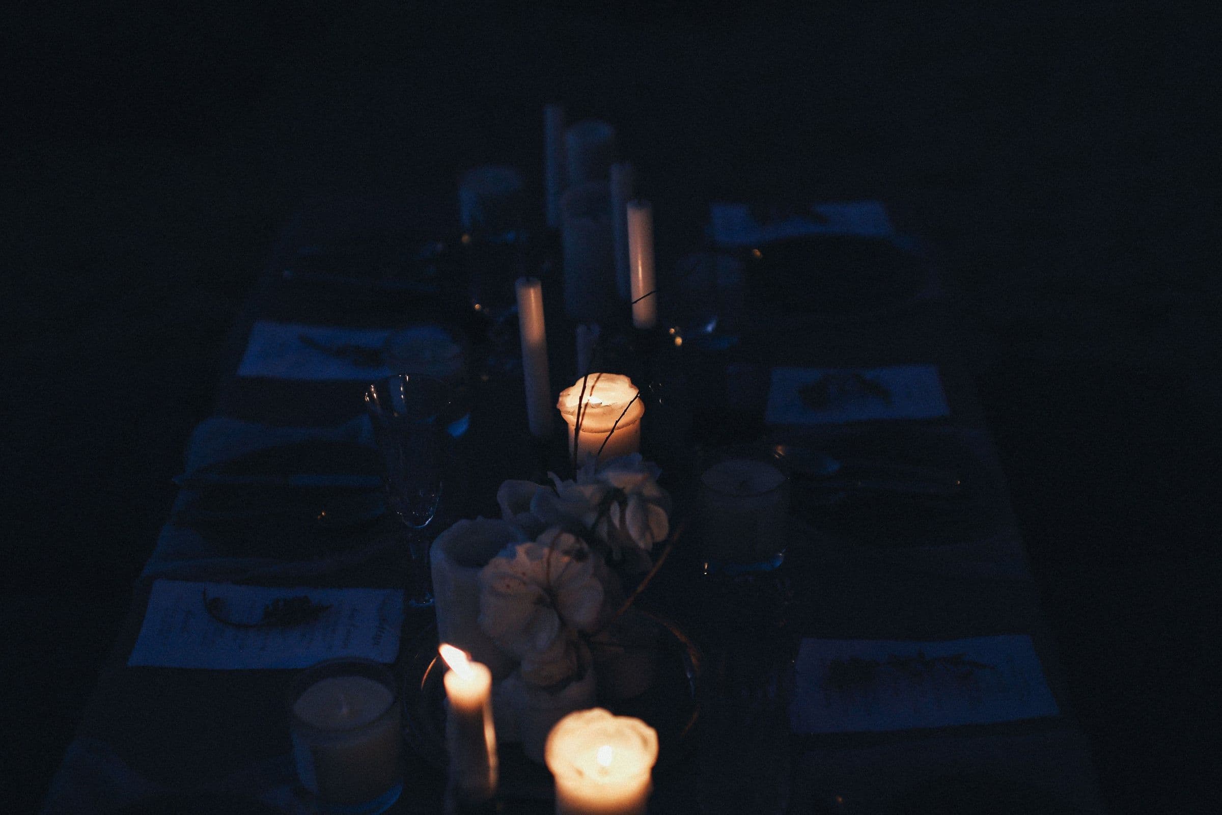 A laid table set for the tasting menu, candlelight low